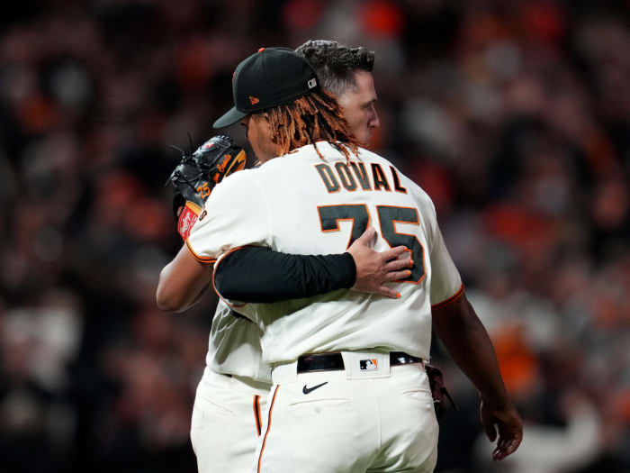 Oct 8, 2021; San Francisco, California, USA; San Francisco Giants catcher Buster Posey (28) hugs relief pitcher Camilo Doval (75) after defeating the Los Angeles Dodgers in game one of the 2021 NLDS at Oracle Park.